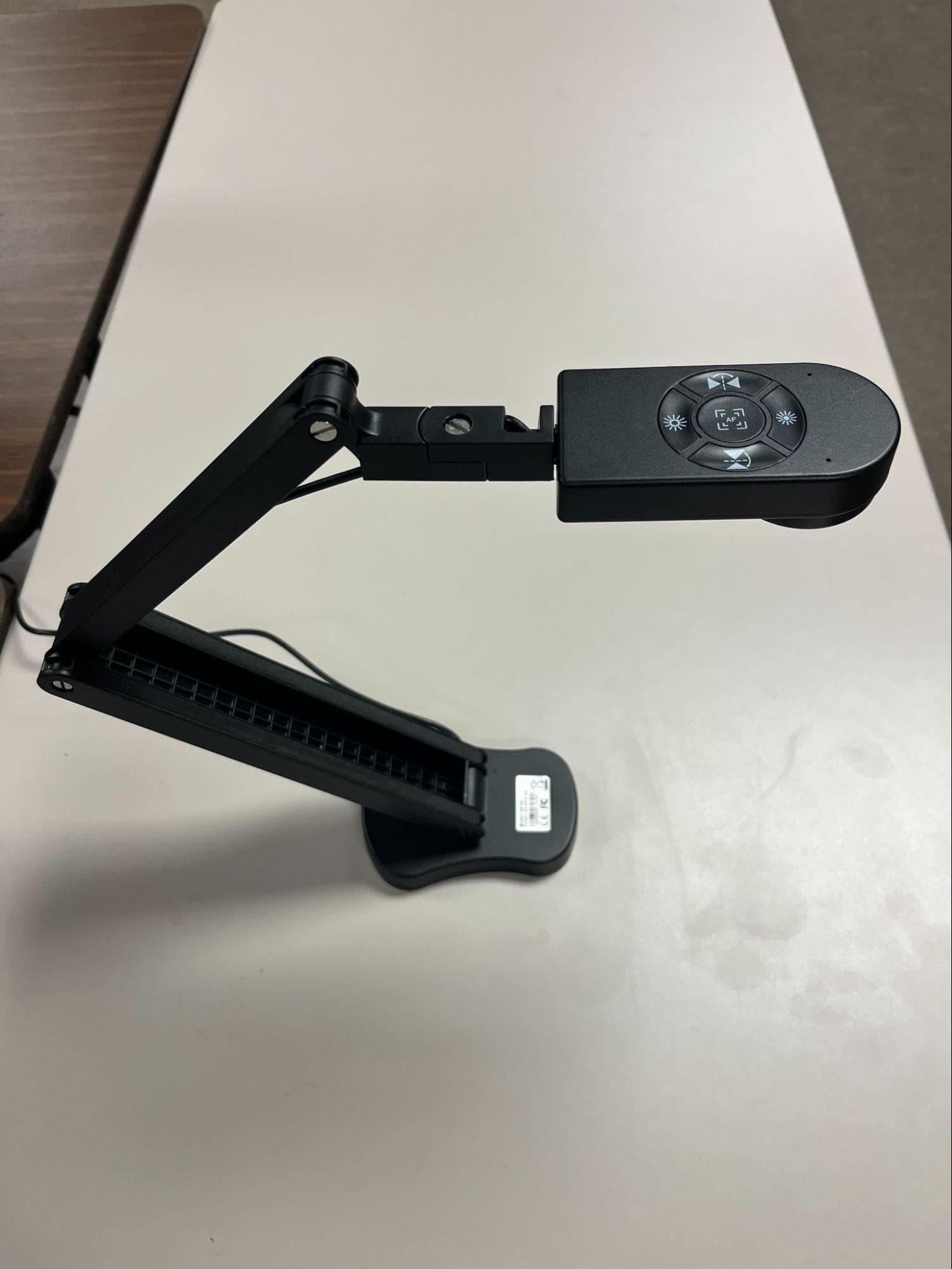 PaKOTOO KB700 document camera with folding arm and top-mounted control buttons (autofocus, light, and tilt)
