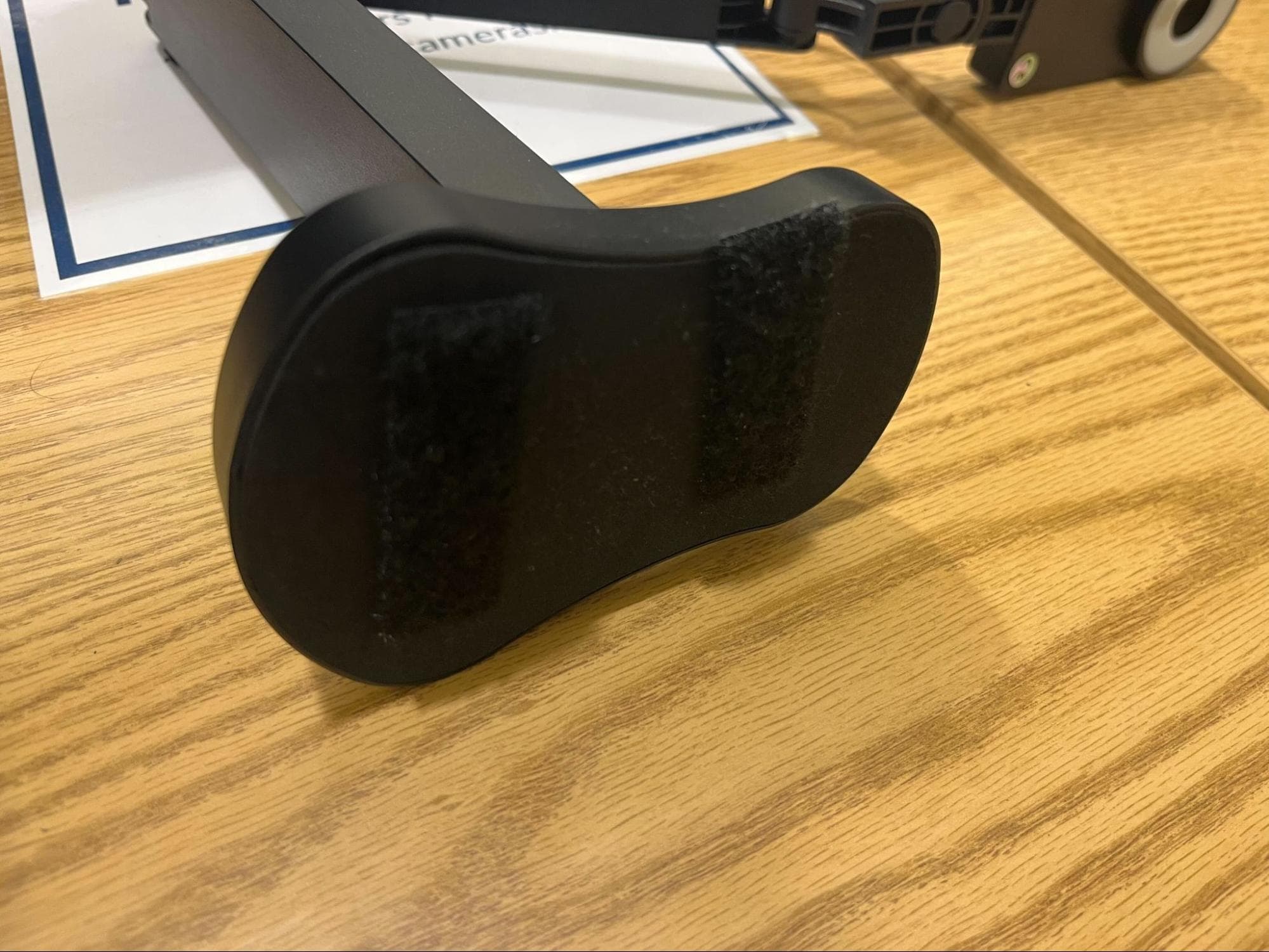 Underside of the document camera base with two Velcro strips that mate with the strips on the monitor base